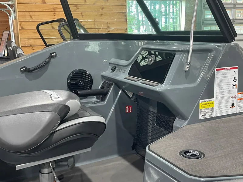 Slide: The Image of 2025 Lund 185 Impact GL boat interior with modern dashboard and seating. - 11
