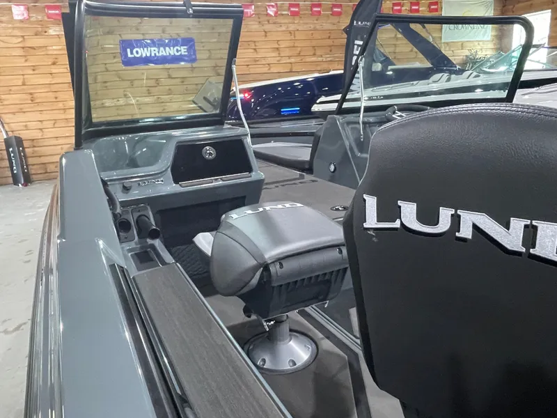 Slide: The Image of 2025 Lund 185 Impact GL boat interior with Lowrance equipment, featuring sleek seating and dashboard. - 13