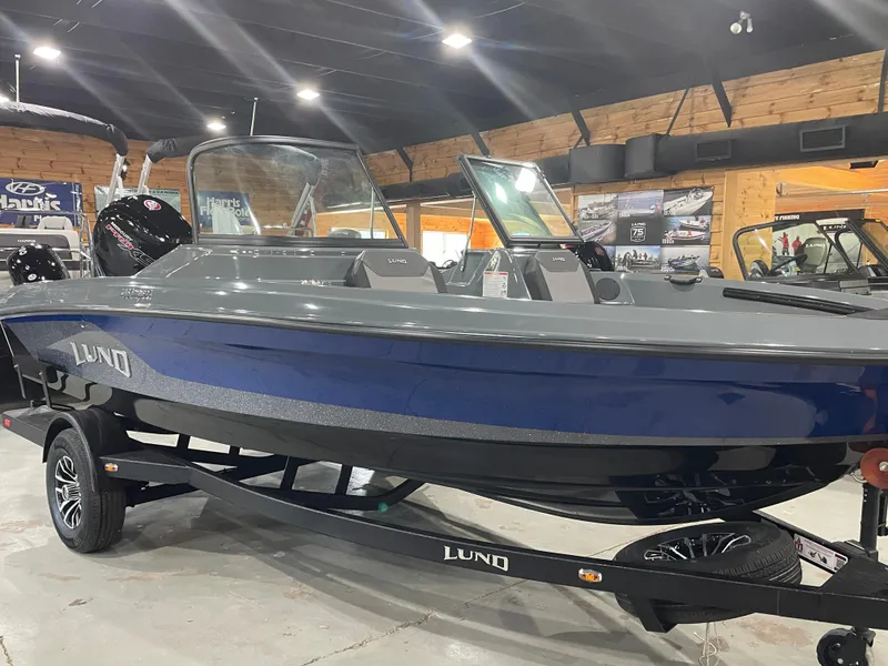 Slide: The Image of 2025 Lund 185 Impact GL boat displayed indoors, featuring sleek design and modern features. - 4