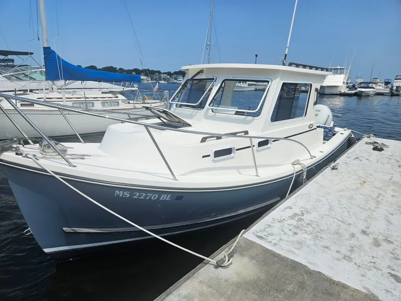Slide: The Image of 2019 Eastern 248 Explorer boat docked at marina on a sunny day. - 21