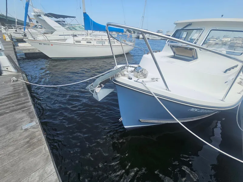 Slide: The Image of 2019 Eastern 248 Explorer boat docked at marina, adjacent to sailboats. - 23