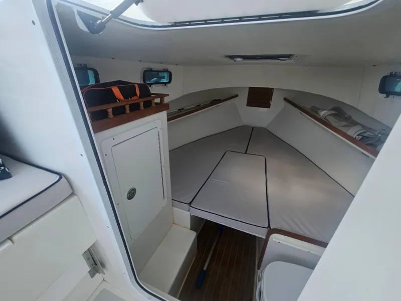 Slide: The Image of Interior cabin of 2019 Eastern 248 Explorer boat, featuring seating and storage. - 27