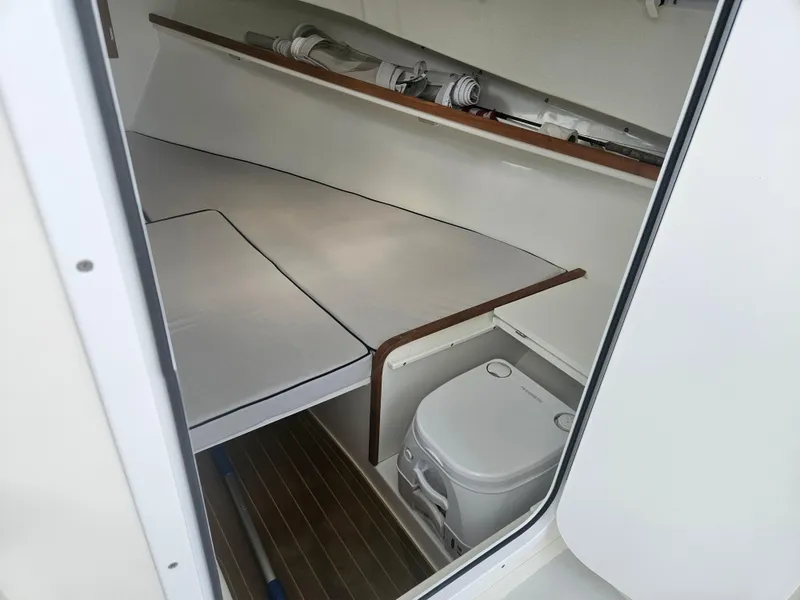 Slide: The Image of 2019 Eastern 248 Explorer cabin interior with bed and portable toilet. - 28