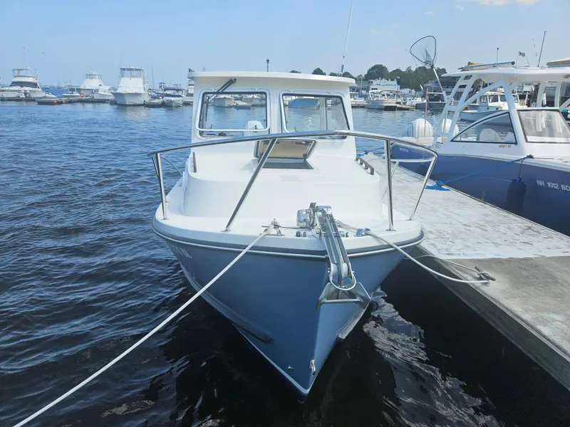 Slide: The Image of 2019 Eastern 248 Explorer boat docked at marina, surrounded by other vessels. - 3