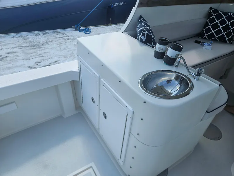 Slide: The Image of 2019 Eastern 248 Explorer boat interior with sink, seating, and nautical decor. - 33