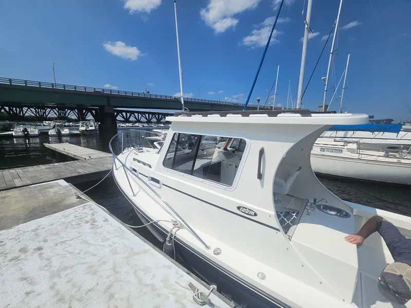 Slide: The Image of 2019 Eastern 248 Explorer boat docked by a bridge on a sunny day. - 5