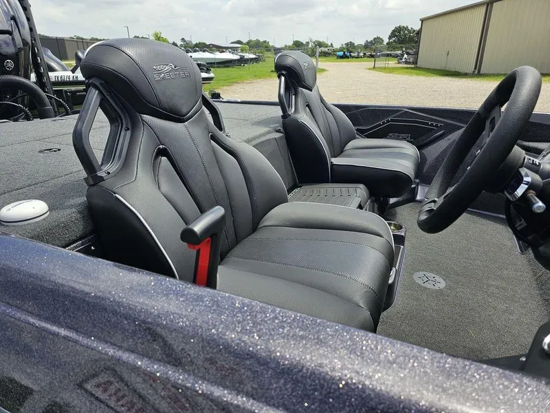 Slide: The Image of 2023 Skeeter ZXR 20 boat interior with sleek black seats and steering wheel. - 12