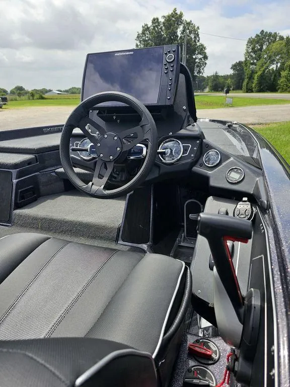 Slide: The Image of 2023 Skeeter ZXR 20 boat interior with steering wheel and control panel. - 6