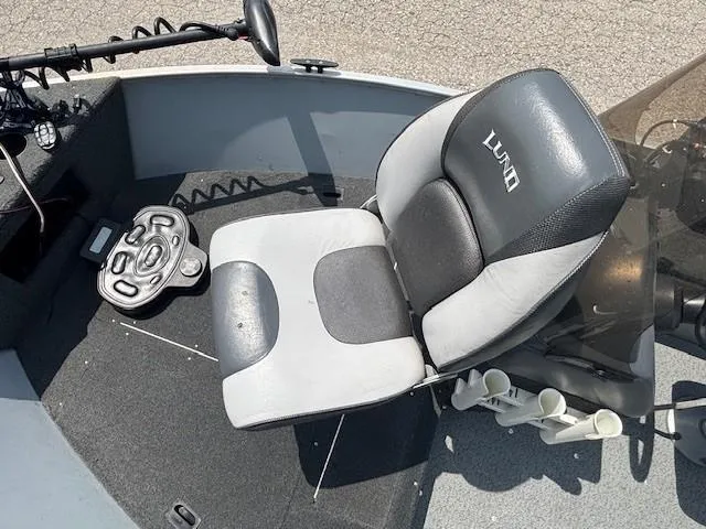 Slide: The Image of 2013 Lund 1400 Fury SS boat interior with seat and steering controls. - 10