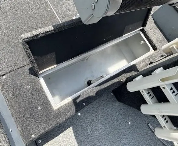 Slide: The Image of 2013 Lund 1400 Fury SS boat storage compartment with open hatch, showcasing interior space. - 12