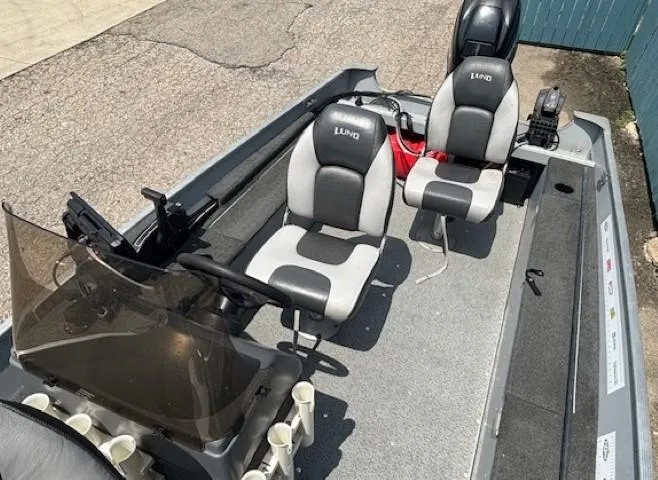 Slide: The Image of 2013 Lund 1400 Fury SS boat interior with two seats and steering console. - 17