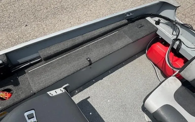 Slide: The Image of Interior of a 2013 Lund 1400 Fury SS boat showing seating and storage area. - 18