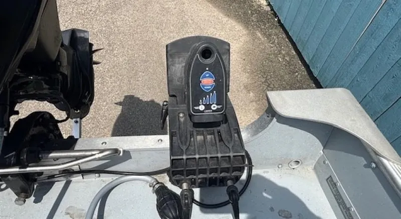 Slide: The Image of 2013 Lund 1400 Fury SS boat motor control panel with cables, on a paved surface. - 22