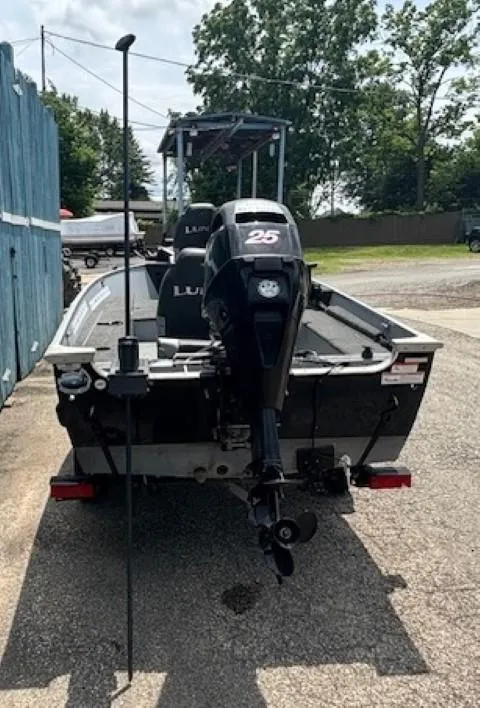 Slide: The Image of 2013 Lund 1400 Fury SS boat on trailer, rear view with outboard motor. - 25