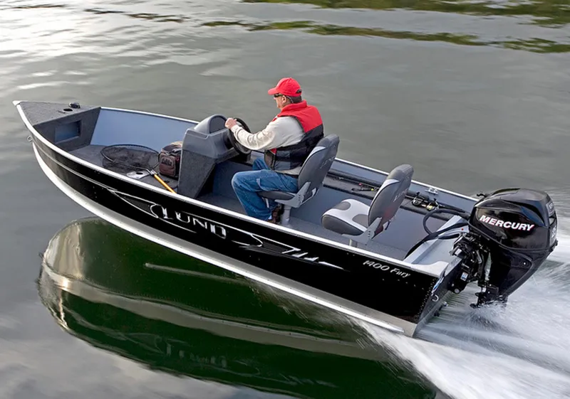 Slide: The Image of Manufacturer Provided Image: 2013 Lund 1400 Fury SS boat on water with Mercury outboard motor. - 26