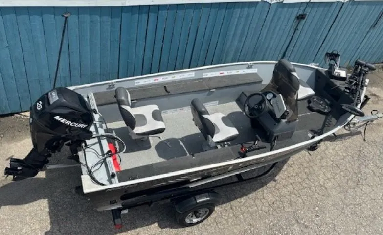 Slide: The Image of 2013 Lund 1400 Fury SS fishing boat with Mercury outboard motor, parked on trailer. - 5