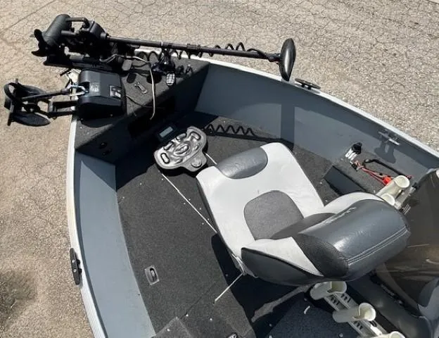 Slide: The Image of 2013 Lund 1400 Fury SS boat interior with seat and trolling motor. - 6