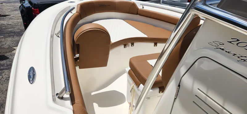 Slide: The Image of 2026 Pioneer 202 Sportfish boat interior with tan and white seating, showcasing luxury design. - 12