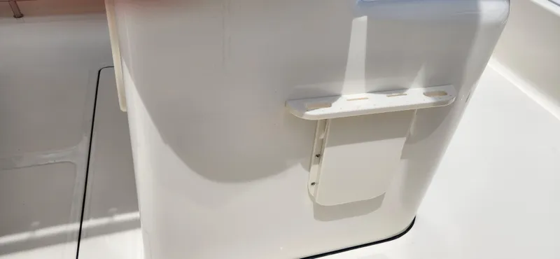 Slide: The Image of 2026 Pioneer 202 Sportfish boat interior detail, featuring a white console with mounted accessory holder. - 7