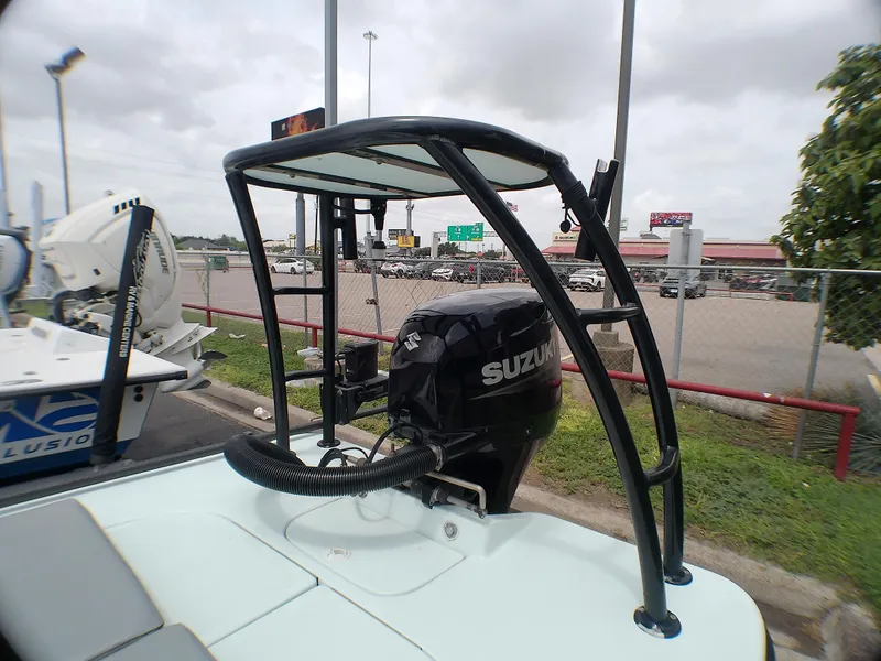 Slide: The Image of 2016 Ankona Copperhead boat with Suzuki outboard motor in a parking lot. - 13
