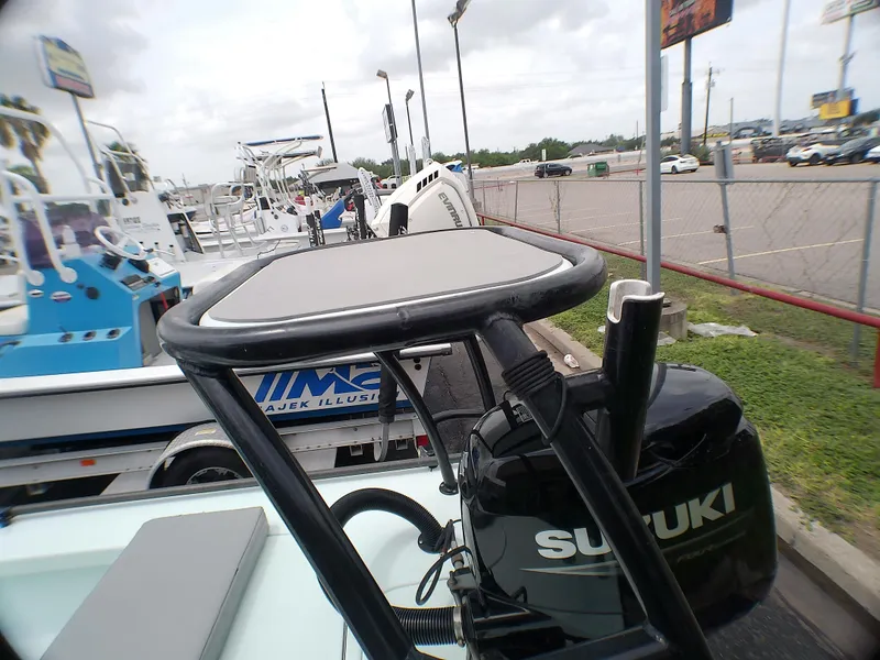 Slide: The Image of 2016 Ankona Copperhead boat with Suzuki outboard motor in a parking lot. - 14