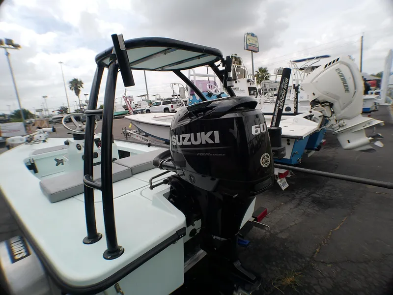 Slide: The Image of 2016 Ankona Copperhead boat with Suzuki 60 outboard motor, displayed outdoors. - 15