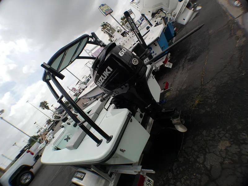 Slide: The Image of 2016 Ankona Copperhead boat with Suzuki outboard motor, parked on a trailer. - 18