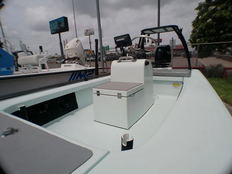 Slide: The Image of 2016 Ankona Copperhead boat interior with console and seating, under cloudy sky. - 3