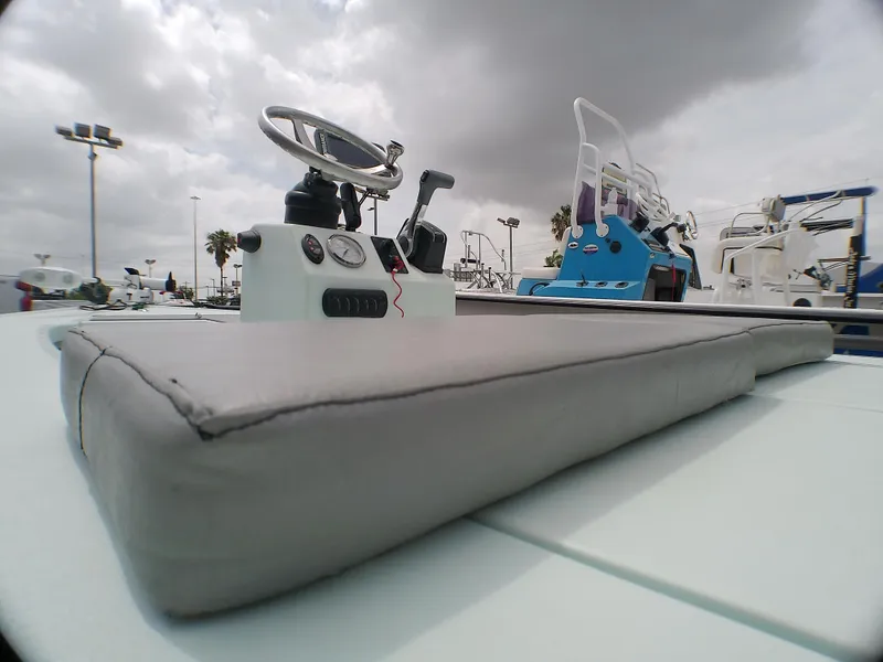 Slide: The Image of 2016 Ankona Copperhead boat with steering console, under cloudy sky. - 9