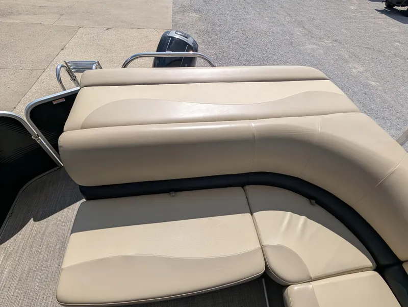 Slide: The Image of 2016 Manitou 23 Aurora boat with beige seating and a sleek design. - 14