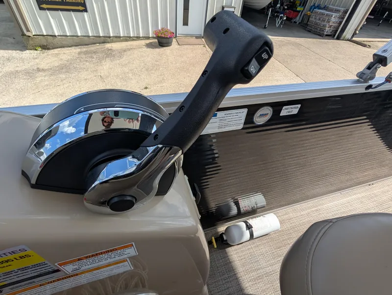 Slide: The Image of Throttle control on 2016 Manitou 23 Aurora boat, with visible safety labels and fire extinguisher. - 20