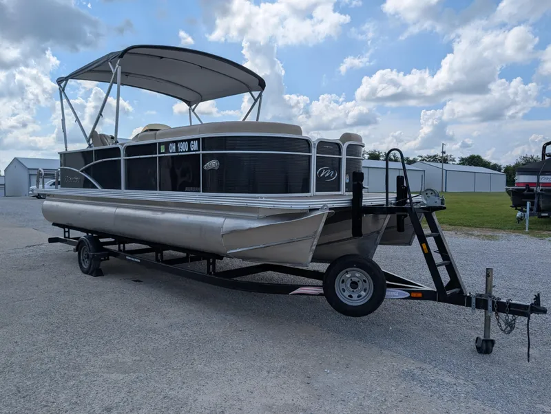Slide: The Image of 2016 Manitou 23 Aurora pontoon boat on trailer under cloudy sky. - 4