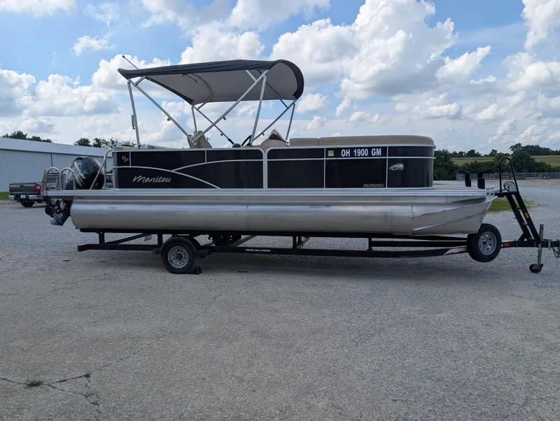 Slide: The Image of 2016 Manitou 23 Aurora pontoon boat on trailer under cloudy sky. - 5
