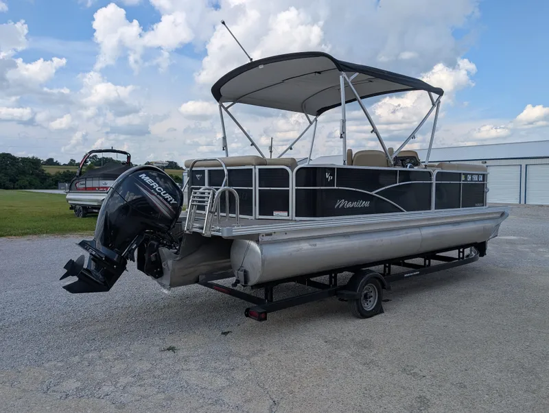 Slide: The Image of 2016 Manitou 23 Aurora pontoon boat with Mercury outboard engine on trailer. - 6