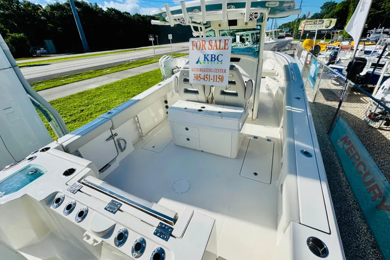 Slide: The Image of 2026 Sailfish 312 CC boat for sale at KBC, featuring spacious deck and seating. - 9