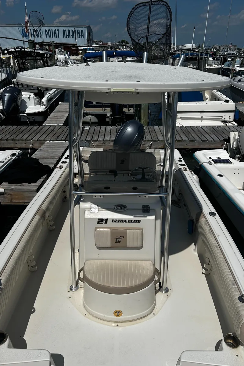 Slide: The Image of 2015 Carolina Skiff 21 Ultra Elite boat docked at marina under clear sky. - 16