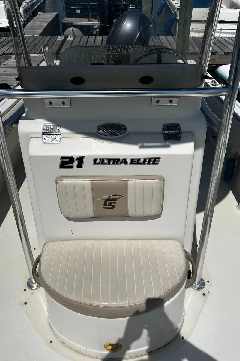 Slide: The Image of 2015 Carolina Skiff 21 Ultra Elite boat console with seating and steering wheel. - 18