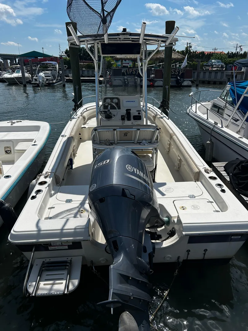 Slide: The Image of 2015 Carolina Skiff 21 Ultra Elite boat with Yamaha 150 engine docked at marina. - 2