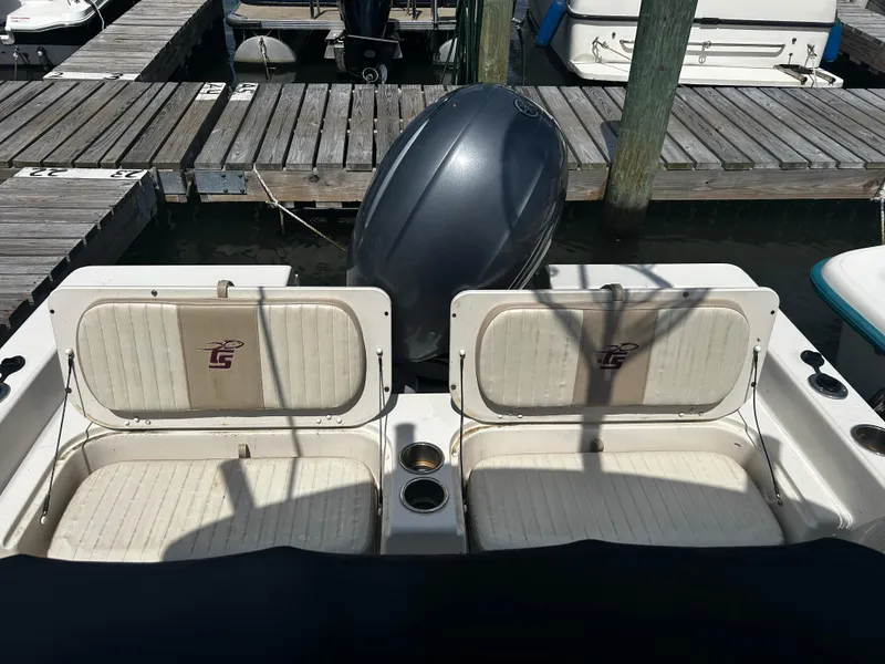 Slide: The Image of 2015 Carolina Skiff 21 Ultra Elite boat seats and motor at dock. - 24