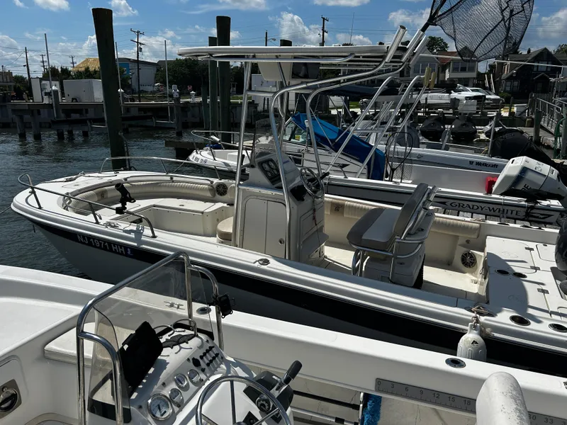 Slide: The Image of 2015 Carolina Skiff 21 Ultra Elite boat docked at marina under clear sky. - 30