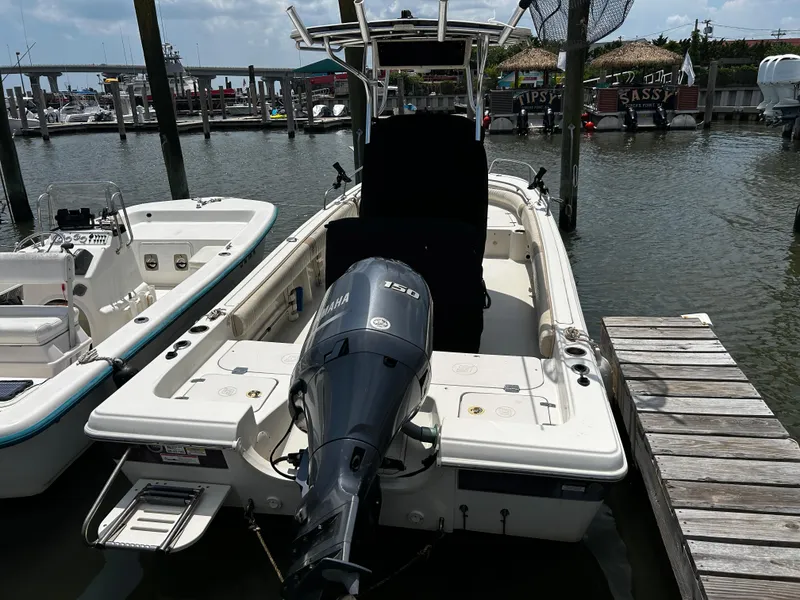 Slide: The Image of 2015 Carolina Skiff 21 Ultra Elite boat docked with Yamaha outboard motor. - 5