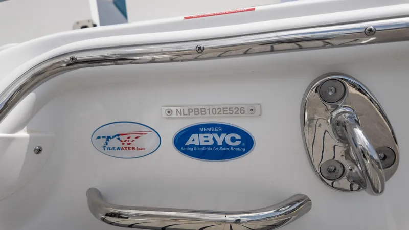 Slide: The Image of 2026 Tidewater 2700 Carolina Bay boat with ABYC and Tidewater logos, close-up view. - 13