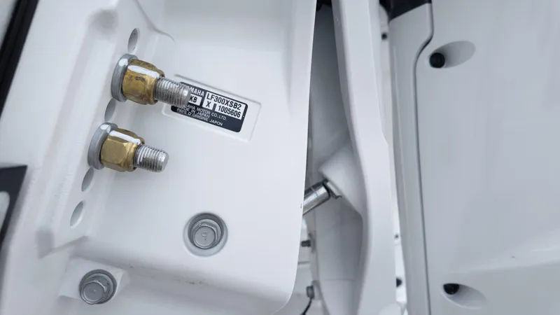 Slide: The Image of Close-up of 2026 Tidewater 2700 Carolina Bay boat engine bolts and label. - 15