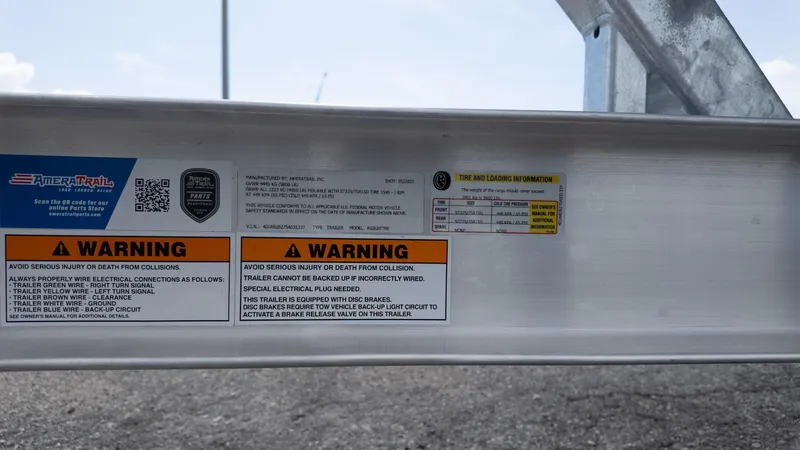 Slide: The Image of Warning labels and tire information on a 2026 Tidewater 2700 Carolina Bay trailer. - 16