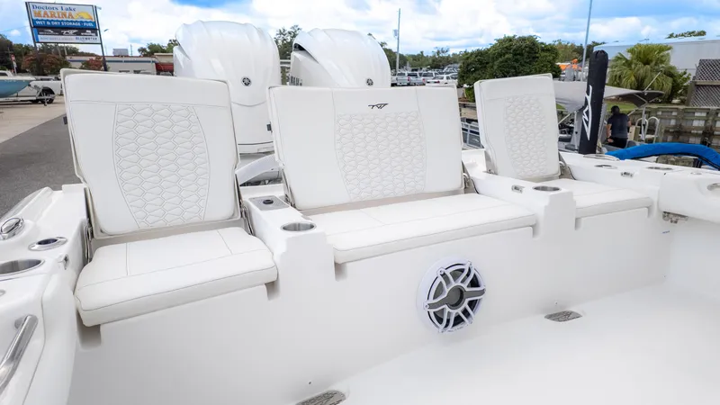 Slide: The Image of 2026 Tidewater 2700 Carolina Bay boat with white cushioned seating and speaker system. - 19