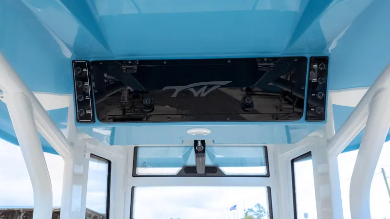 Slide: The Image of 2026 Tidewater 2700 Carolina Bay boat interior with blue ceiling and control panel. - 24