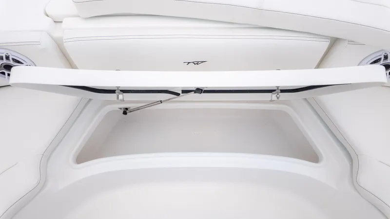 Slide: The Image of 2026 Tidewater 2700 Carolina Bay boat storage compartment with open lid, showcasing interior space. - 29