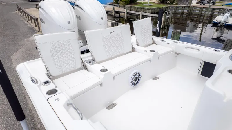 Slide: The Image of 2026 Tidewater 2700 Carolina Bay boat interior with white seating and dual Yamaha engines. - 3
