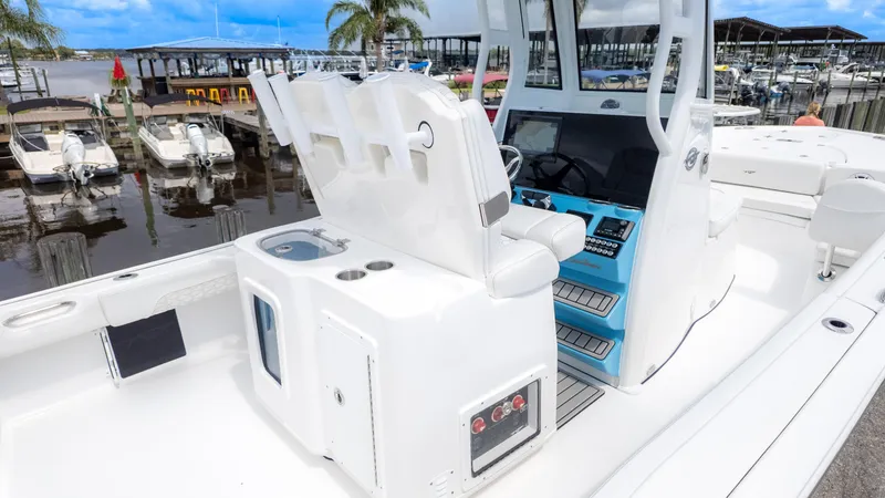 Slide: The Image of 2026 Tidewater 2700 Carolina Bay boat interior with helm, seating, and marina view. - 4