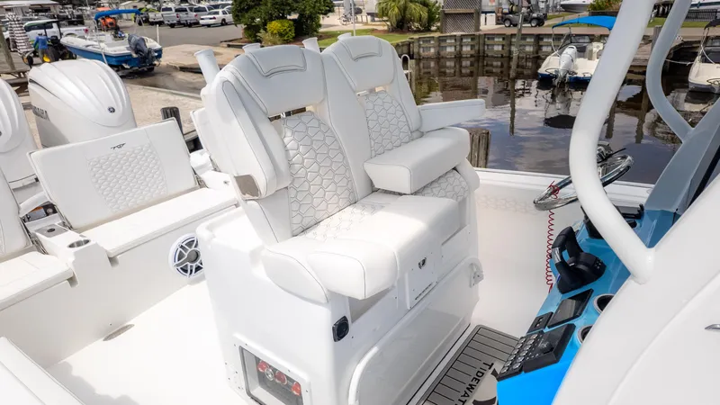 Slide: The Image of 2026 Tidewater 2700 Carolina Bay boat interior with white seating and modern dashboard. - 5